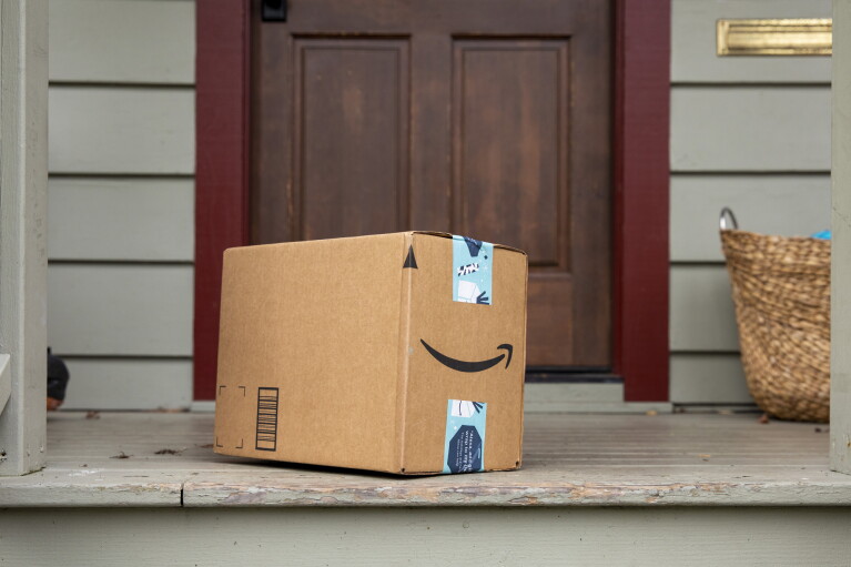 An Amazon package sits on a doorstep.