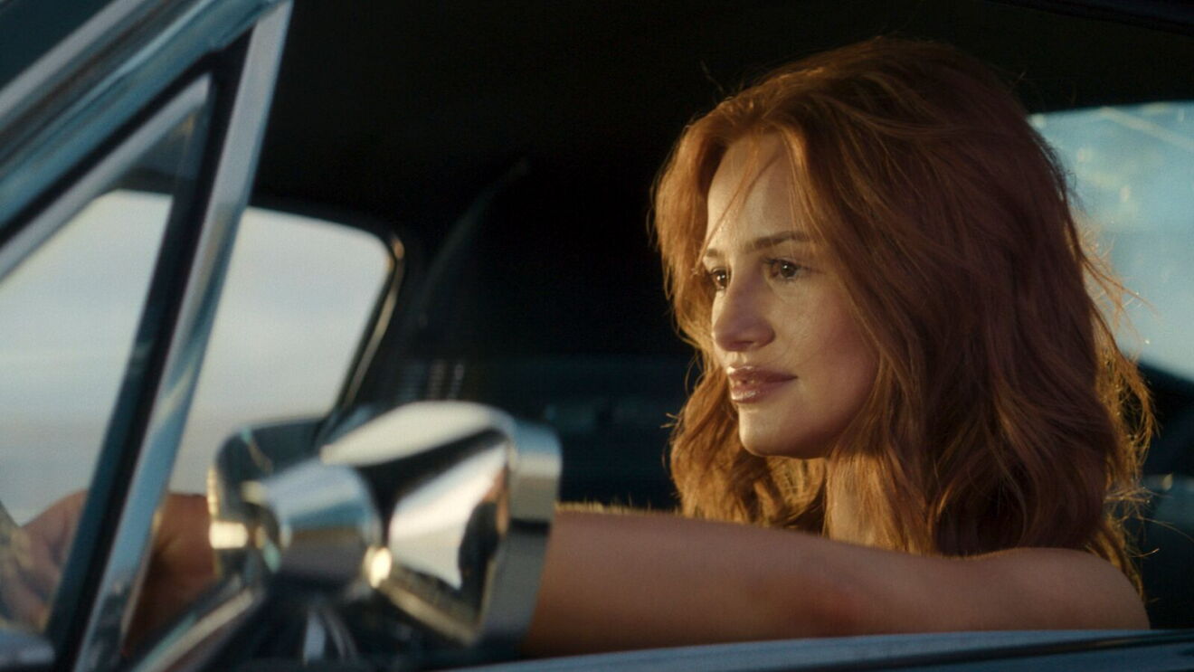 Charlie (Madelaine Petsch) sitting in a vehicle and staring straight ahead