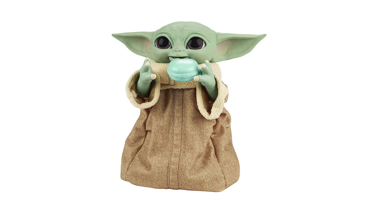 An image of the baby yoda from Star Wars The Mandalorian Galatic holding a tea cup and smiling.