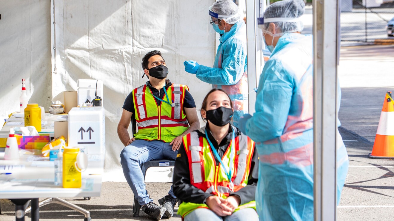 Two workers at the Amazon fulfilment centre in Moorebank, Sydney at the testing site
