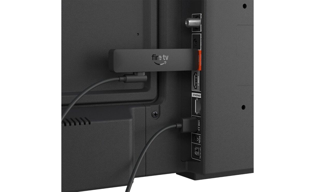 黒い大きな電化製品のクローズアップ。ケーブルやUSBの差込ポートが並び、横長の小さいデバイスが差さっている。小さいデバイスと電化製品はケーブルでつながっている。