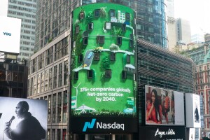 An image of a Climate Pledge Nasdaq Sign on a building that reads "375+ companies globally. Net-zero carbon by 2040."