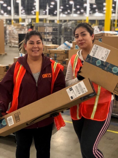 Amazon associates at San Bernardino pose for photos during Cyber Monday. 