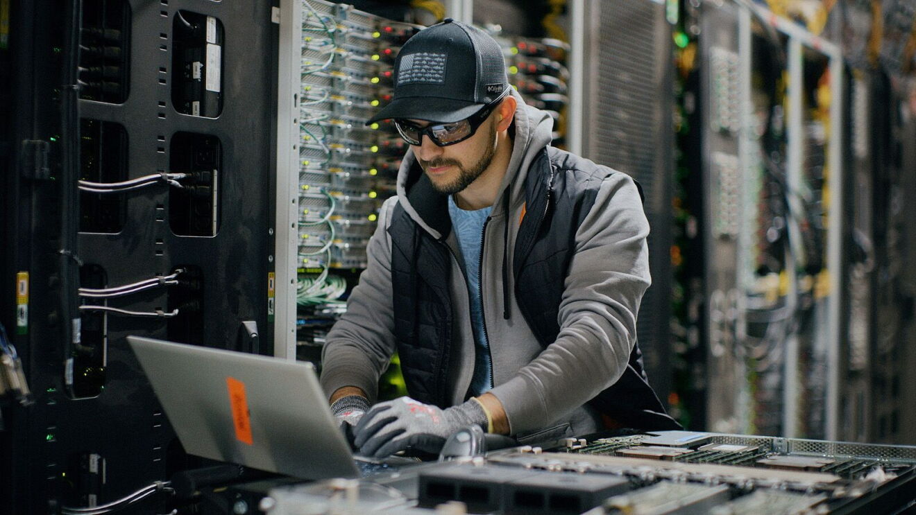 Network engineer maintaining data center equipment