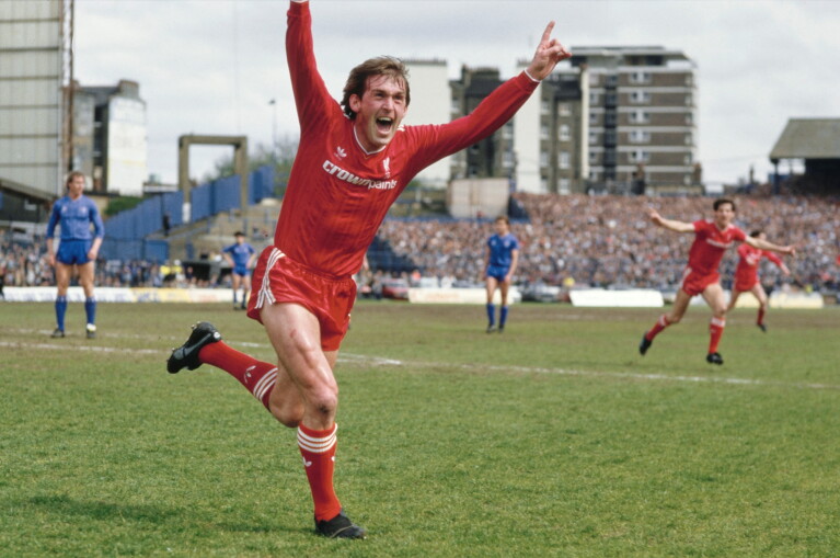 Liverpool player celebrates goal with arms raised in jubilation