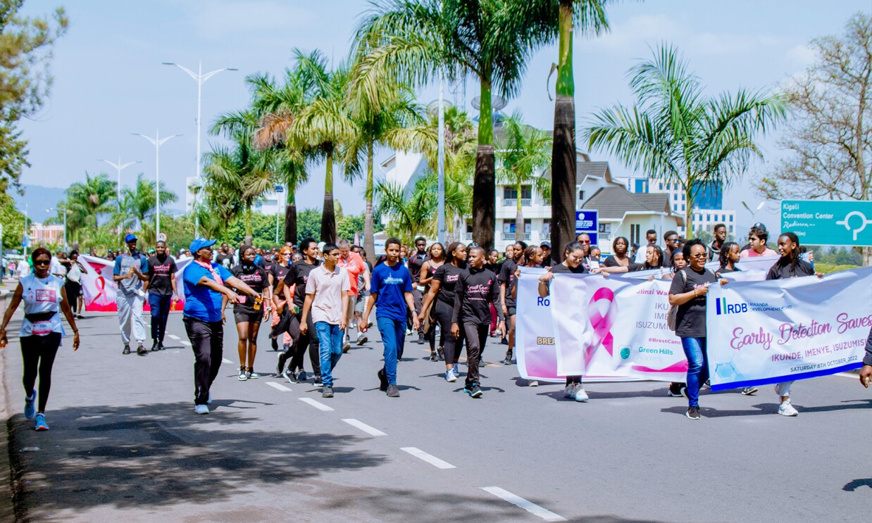 Supporters holding a promotional banner and walking for an Breast Cancer Initiative East Africa (BCIEA) cancer awareness walk.