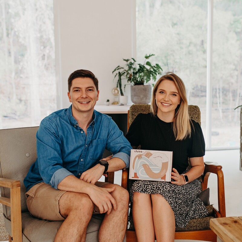 Amazon small business sellers, Ford and Rosa-Clare Willis sit on a sofa with their product in a bright living space