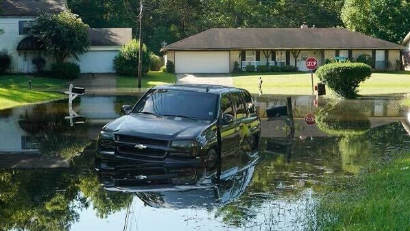 A SUV is stuck and flooded on a street in Jackson, Mississippi.