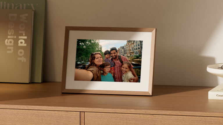 A photo of a family within an Alexa Photo Frame, standing on a table.