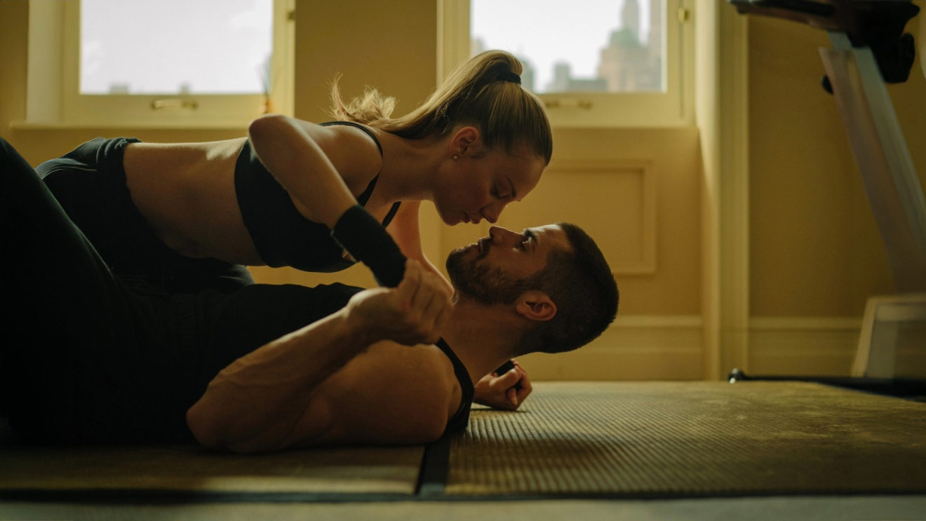 Ester Expósito and Hugo Diego García on top of each other in a dance studio in the film Marfil, also known as Drawn Together, on Prime Video