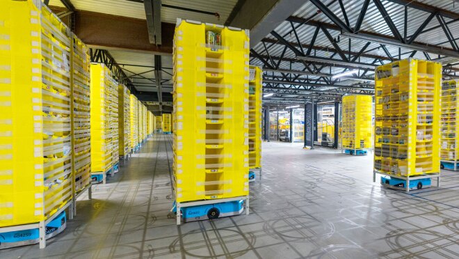 Amazon robots are on their individual tracks bringing products throughout the fulfillment center.