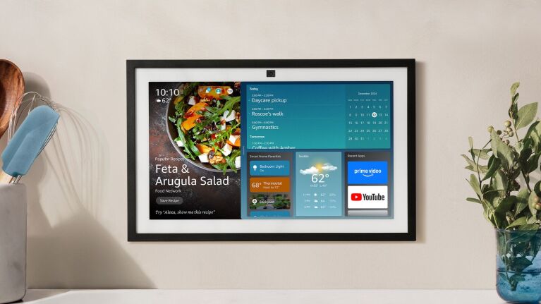 An image of the Amazon Echo Show 15 mounted on a wall with a recipe guide, calendar and weather on its display.