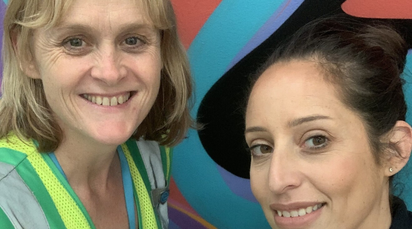 Two MEL1 women employees smile at the camera.