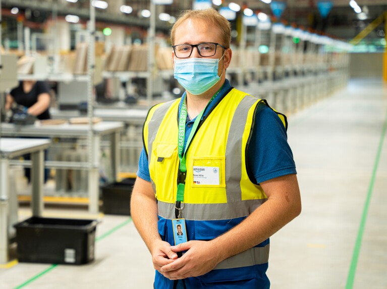 Senior Operations Manager René Hille mit Maske und Weste im Amazon Logistikzentrum in Oelde