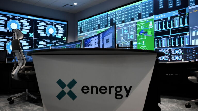 x energy control room and desk with title