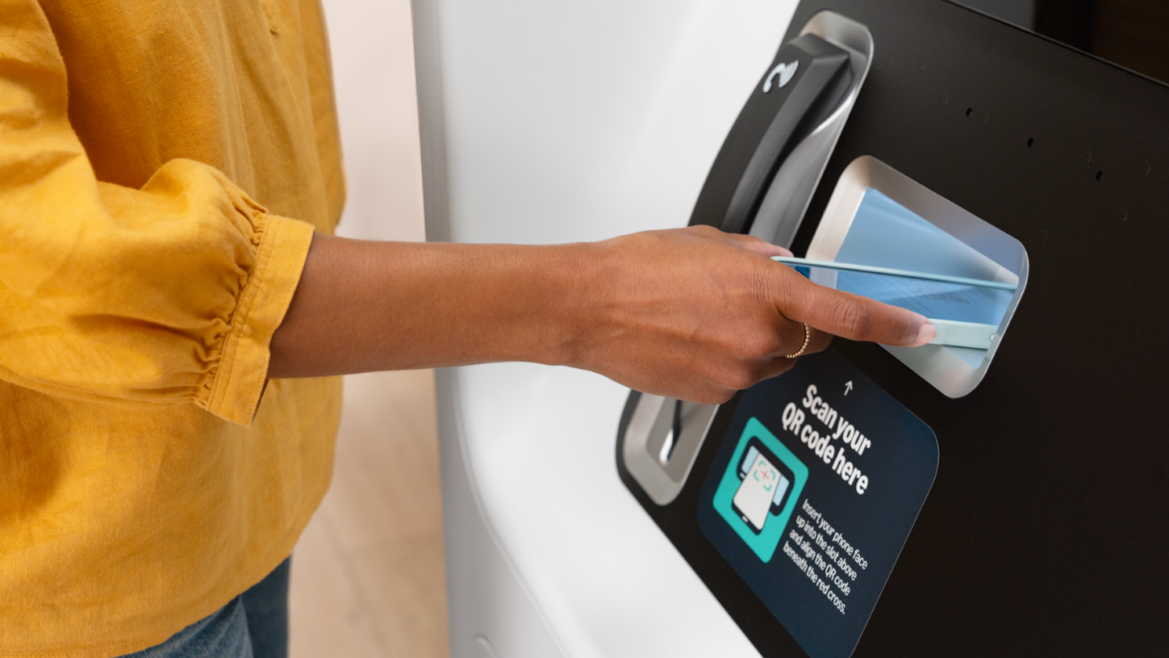 Person scanning QR code at Amazon Pharmacy kiosk