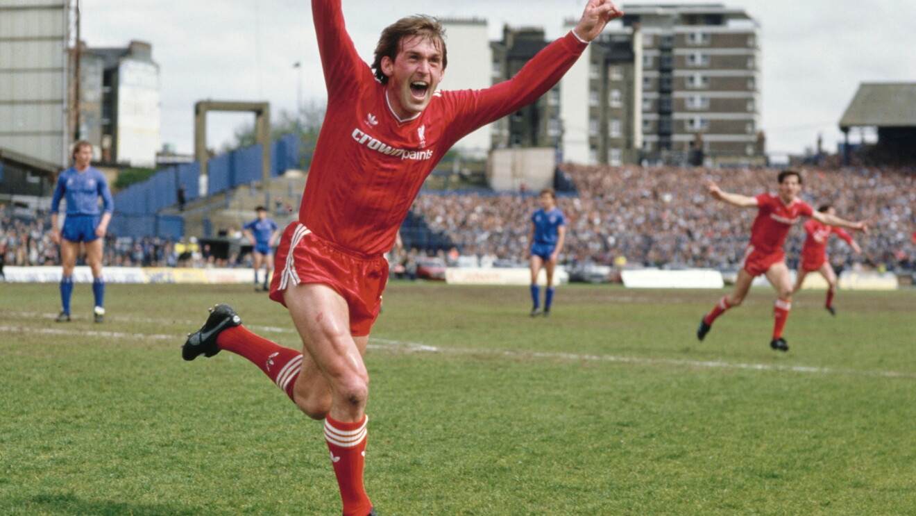 Liverpool player celebrates goal with arms raised in jubilation