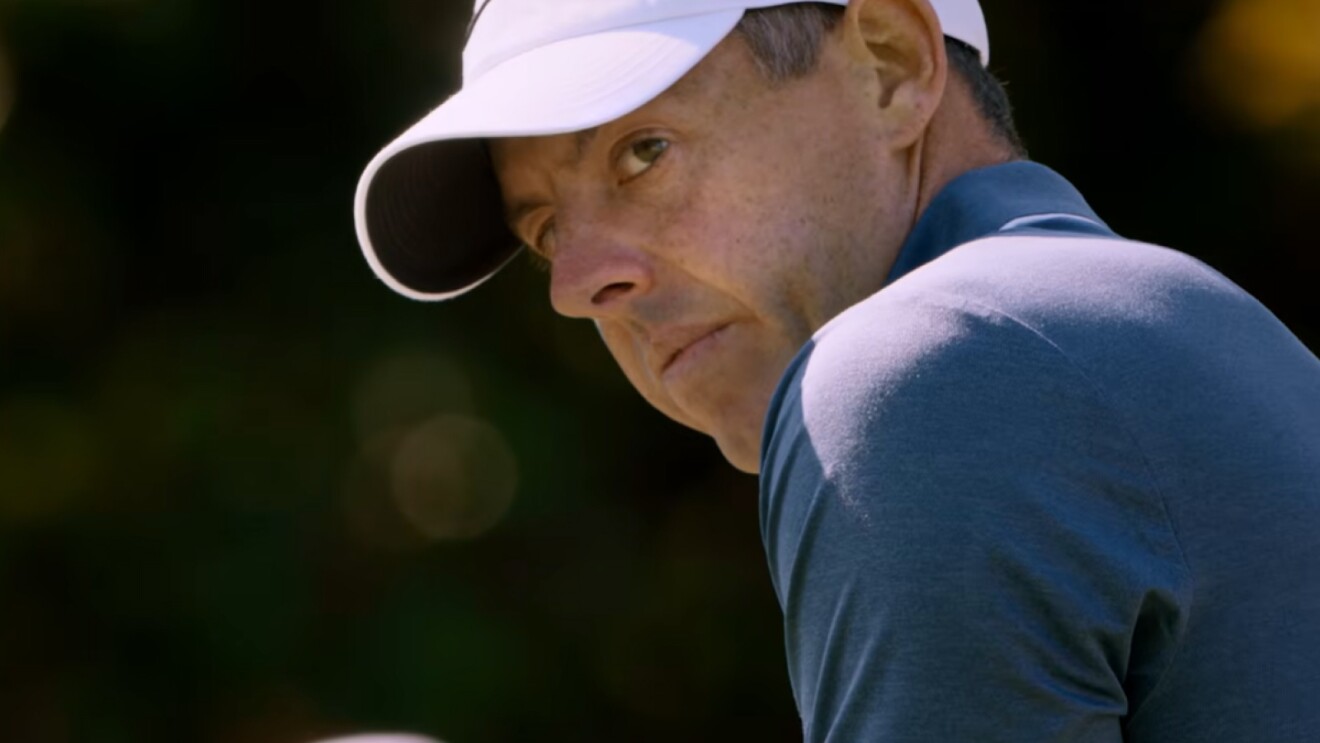 Close up of Rory McIlroy staring intently as he prepares to take a shot at the 2025 Masters