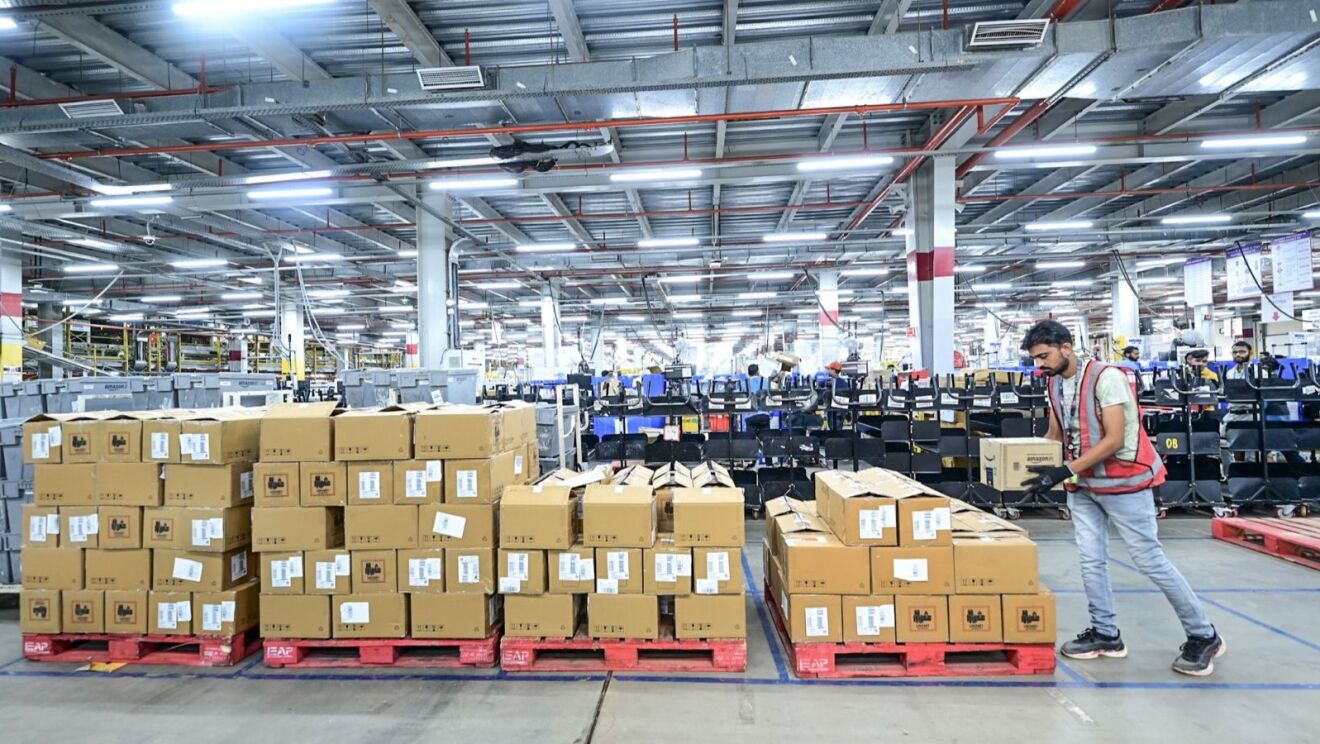An Amazon employee working at a fulfilment centre