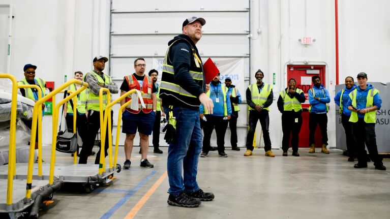 Workplace safety briefing in large warehouse facility
