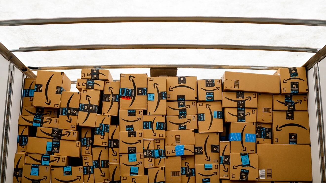 Stacked Amazon parcel boxes in a truck.