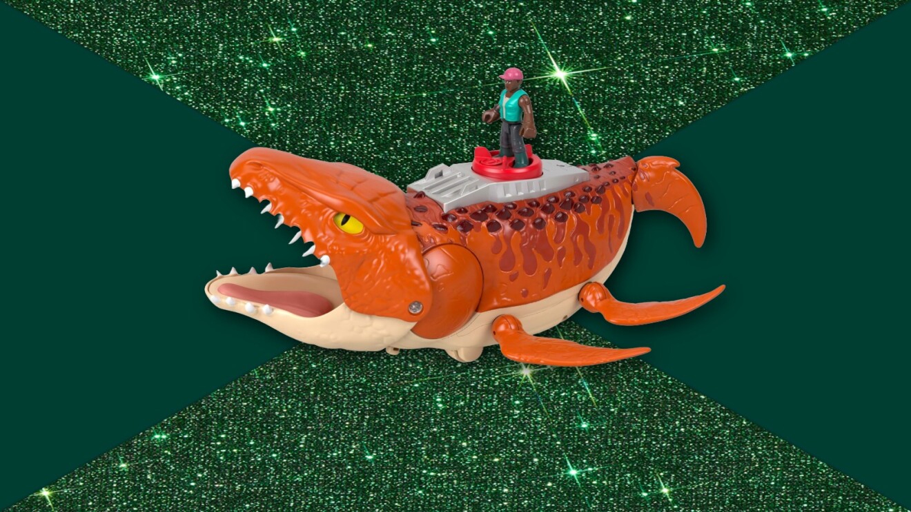 Toy orange sea monster with small figure riding on top against sparkly green background