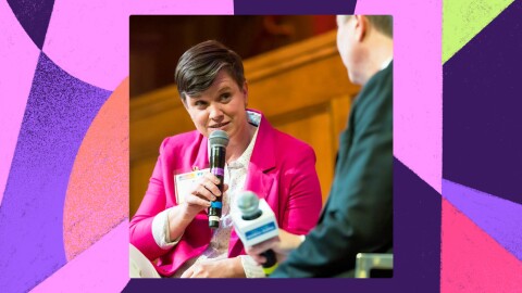 An image of Amazon Community Engagement Manager Keri Pravitz speaking with a microphone in an interview. 