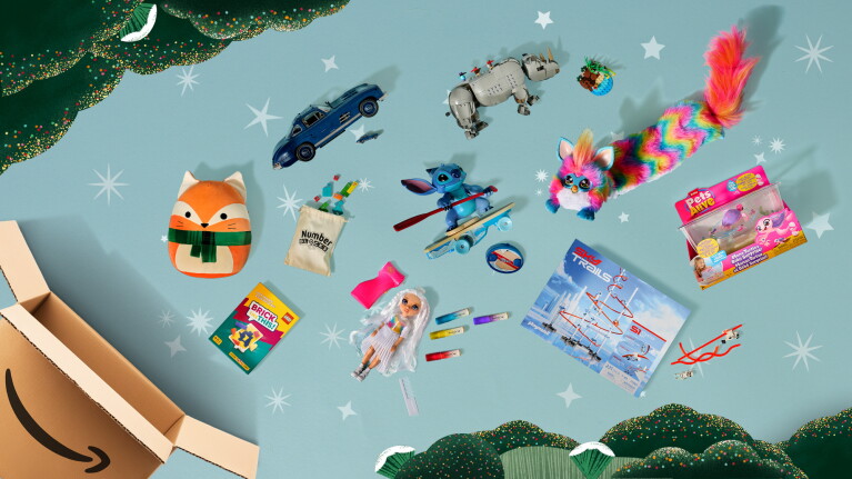 Assortment of toys and gifts spilling from an Amazon box against a starry background