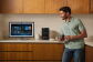 Man in kitchen drinking a coffee and talking to Alexa+