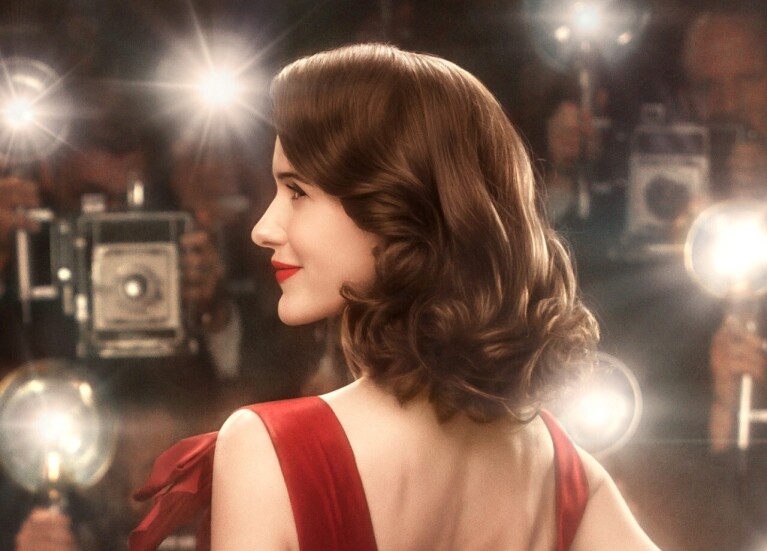 An image of Miriam (Midge) Maisel from the Marvelous Mrs. Maisel. She is on the red carpet with a lot of photographers taking pictures of her.