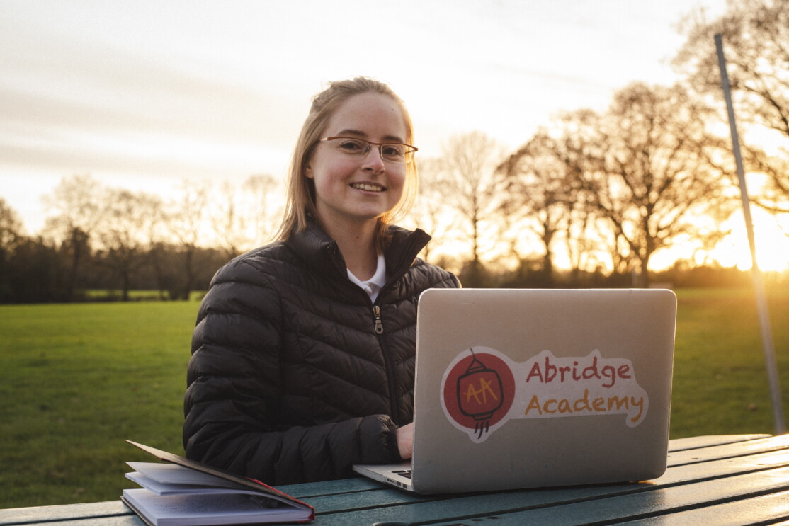 Katie Prescott, founder of Abridge Academy, working on her laptop