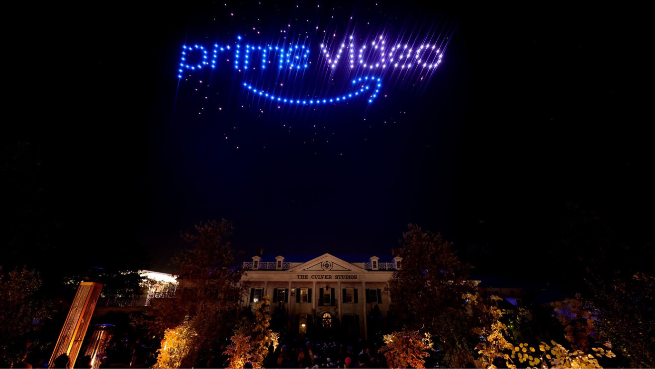 Purple glowing lights in the night sky spell out "Prime Video" and a the Culver City Studios building is below.