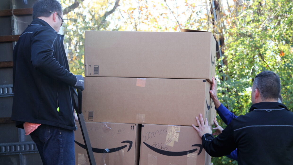 Amazon associates unload supplies for backpacks