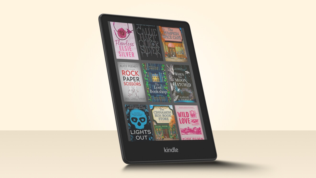 Kindle e-reader displaying various book covers on its screen