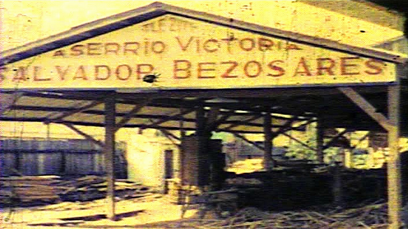 Vintage image of a lumber mill. The painted sign on the building includes the family name "Bezos."