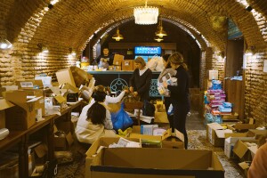 Humanitarian aid workers sort and manage medical supplies for distribution to hospitals, in a cafe basement in Ukraine.