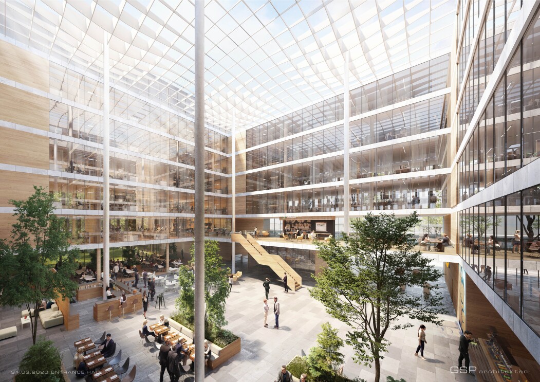 Eine hell erleuchtete Eingangshalle mit vielen Pflanzen  ist auf dem Bild dargestellt.