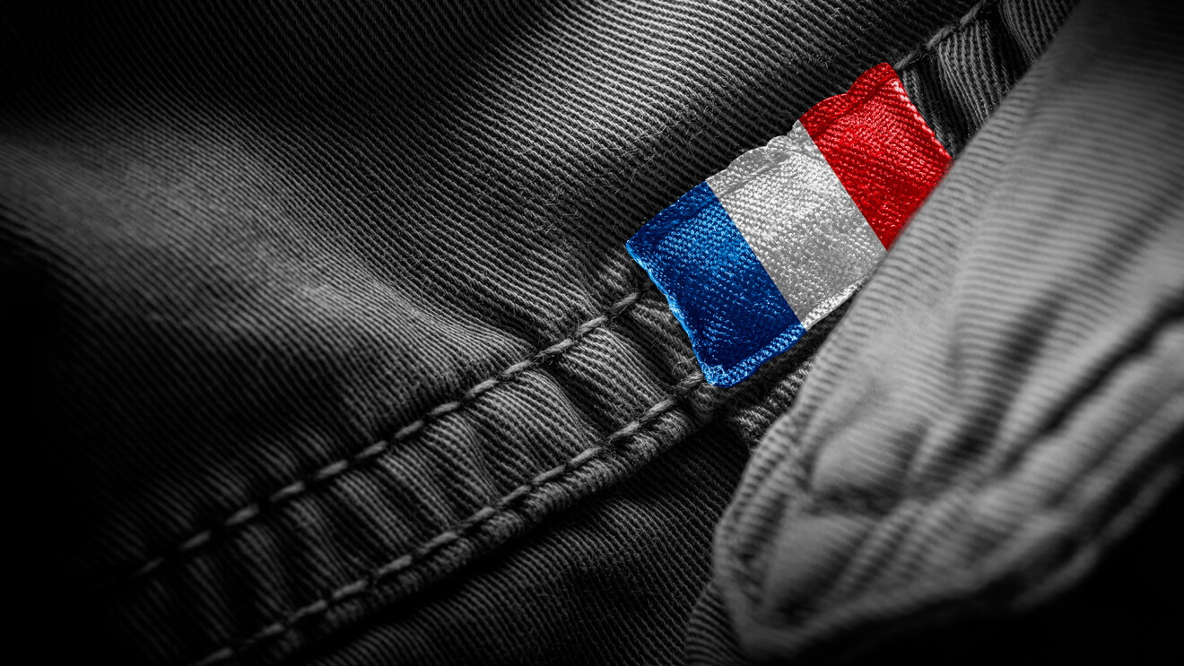 A close up image of a tag representing the French flag on an apparel item 