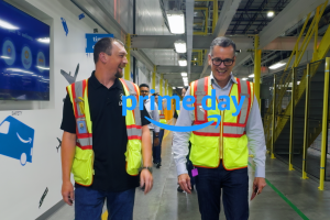 An Amazon employee walks alongside Amazon Stores CEO Doug Herrington