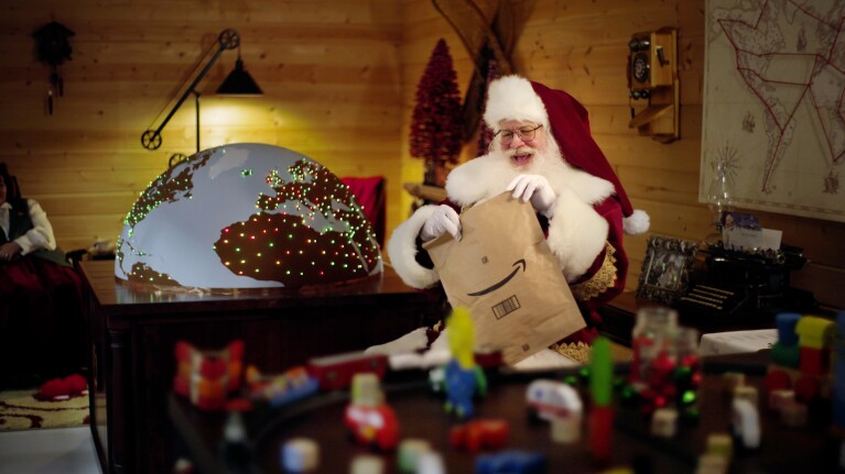 Santa opens an Amazon delivery in the North Pole.