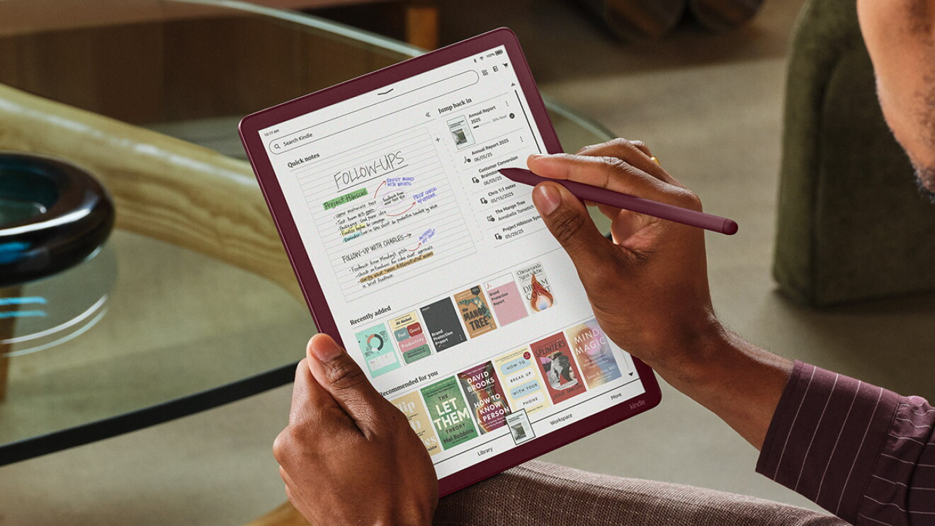 Hands using stylus on kindle colorsoft displaying digital notes and book covers
