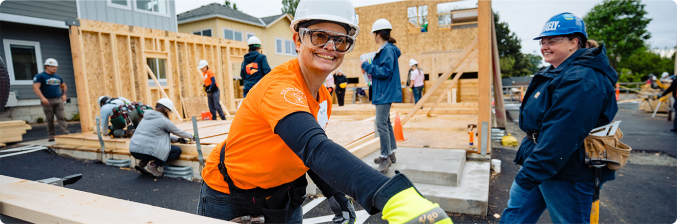 Community build project with diverse team working on wooden frame structure