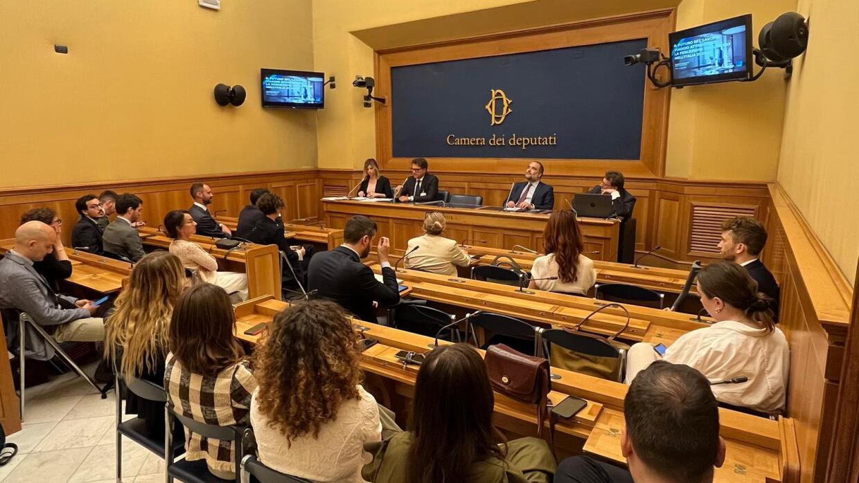 Italian Parliament room with a group of people listening to a panel on the future of workplace