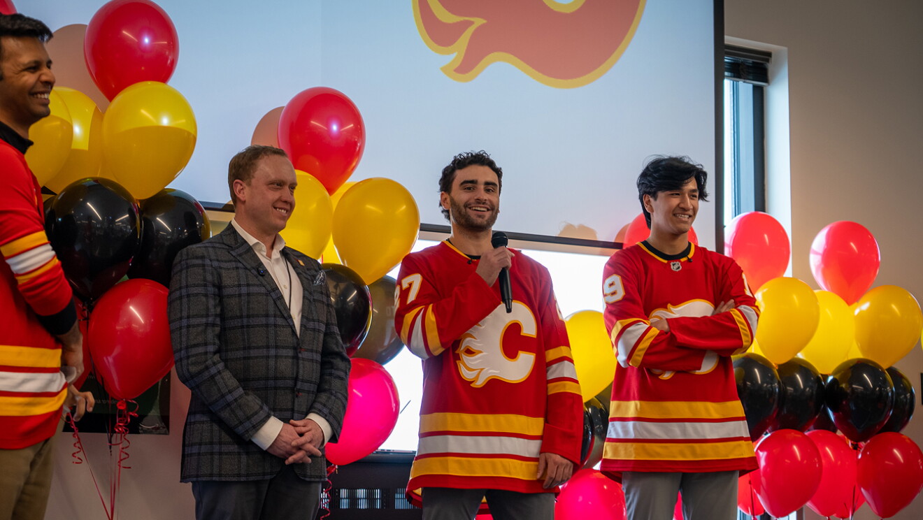 Two Calgary Flames hockey players packing and shipping Amazon boxes