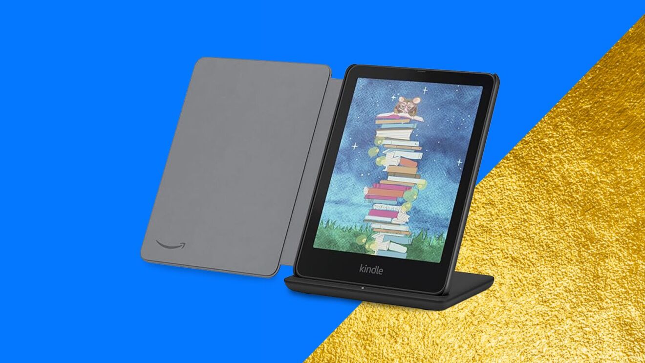 Kindle e-reader displaying whimsical book stack illustration on blue and gold background