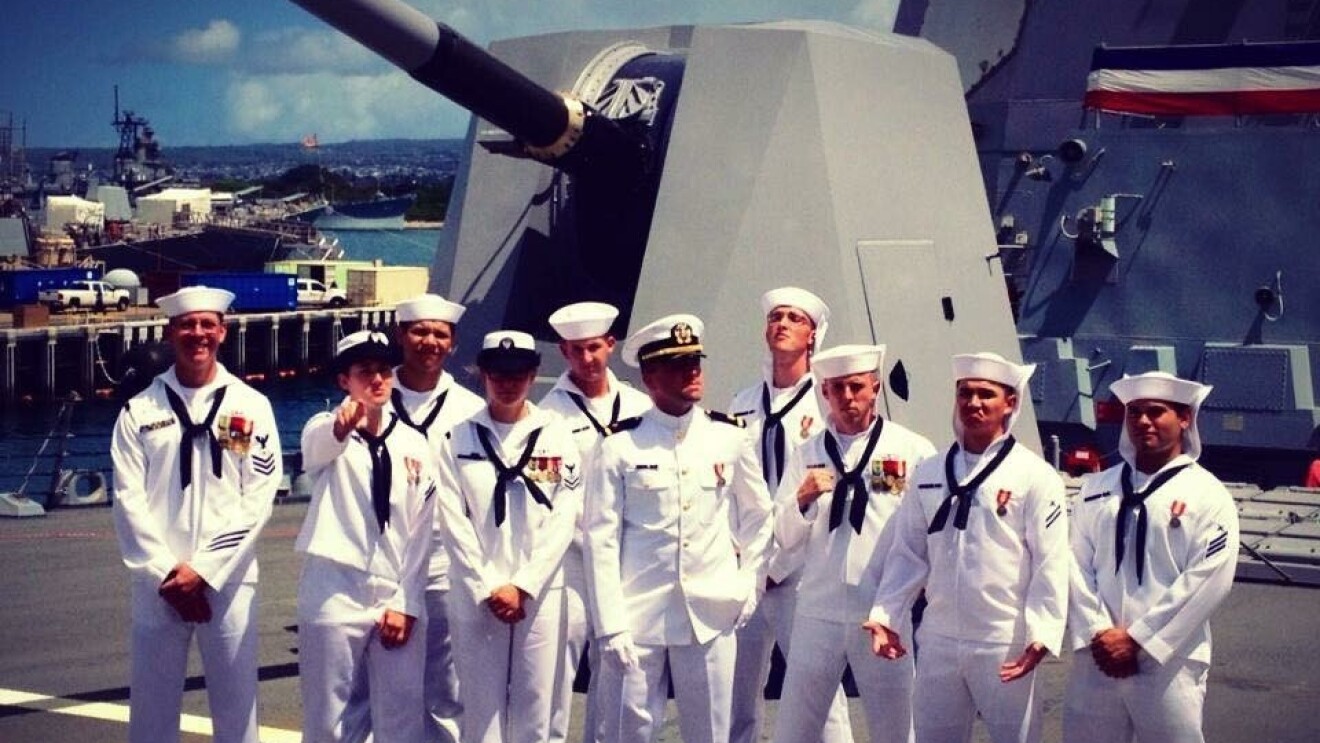 10 members of the U.S. Navy, pose together.