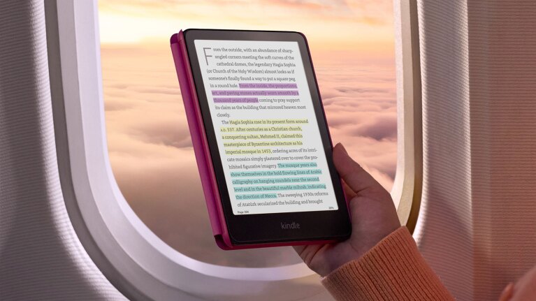 Color Kindle with highlighted text in front of an airplane window