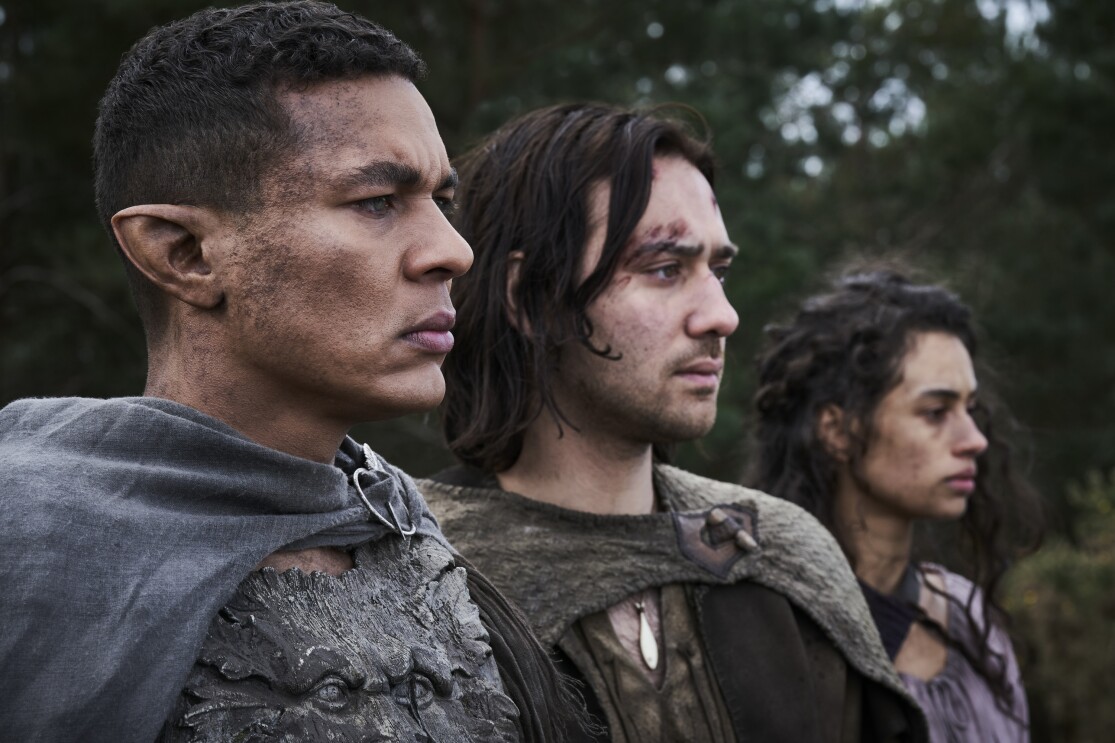 Ismael Cruz Córdova as Arondir, Maxim Baldry as Isildur, and Nia Towle as Estrid in The Lord of the Rings: The Rings of Power on Prime Video