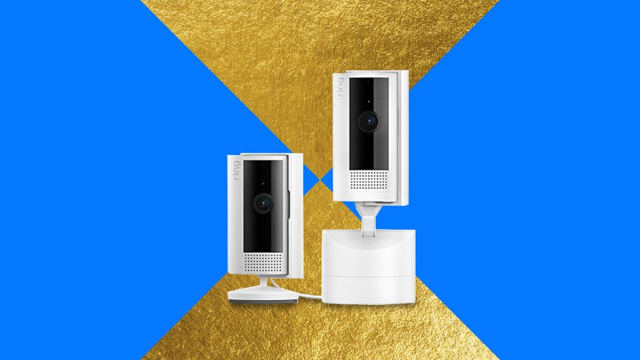 Two white security cameras on stands against blue and gold geometric background
