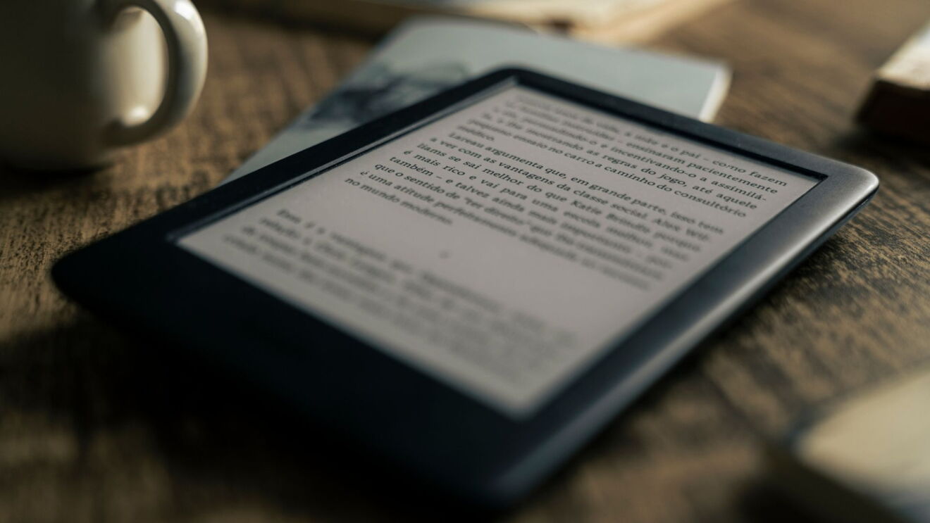 Um Kindle sobre uma mesa de madeira